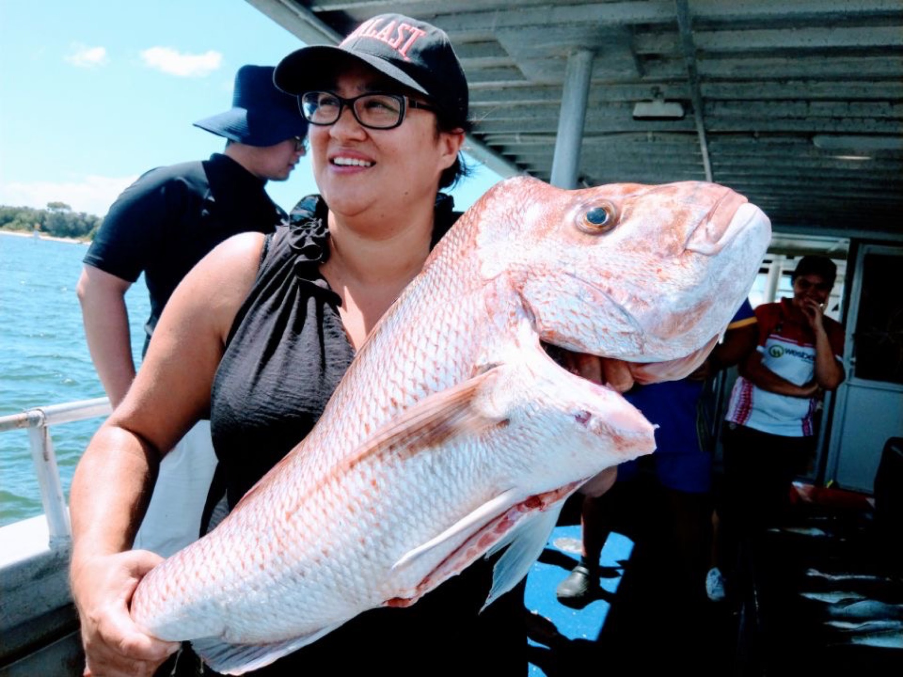 An angler with a big snapper aboard the boat